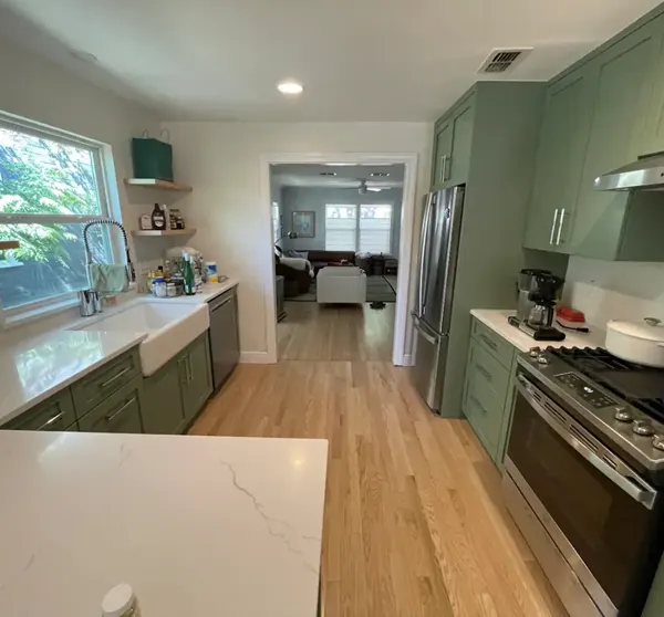 Kitchen remodel with green custom cabinets and farmhouse sink, Pflugerville and Austin area